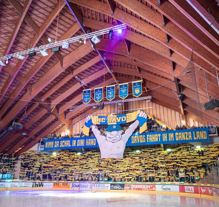 Davos Ice Stadium from inside with yellow, blue mascot (switzerland) | © snow-world.ch